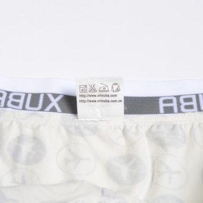 First Class white cotton boxer decorated with blue planes and stars and contains a grey belt