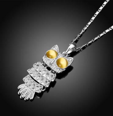 The owl necklace plated with platinum and the eyes are inlaid with brown opals.