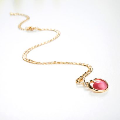 Unique design gold plated necklace inlaid with white crystals and pink opal